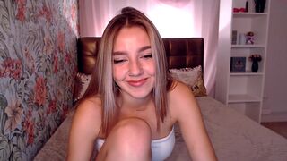 clarecraig busty  cam girl  caresses her lips.